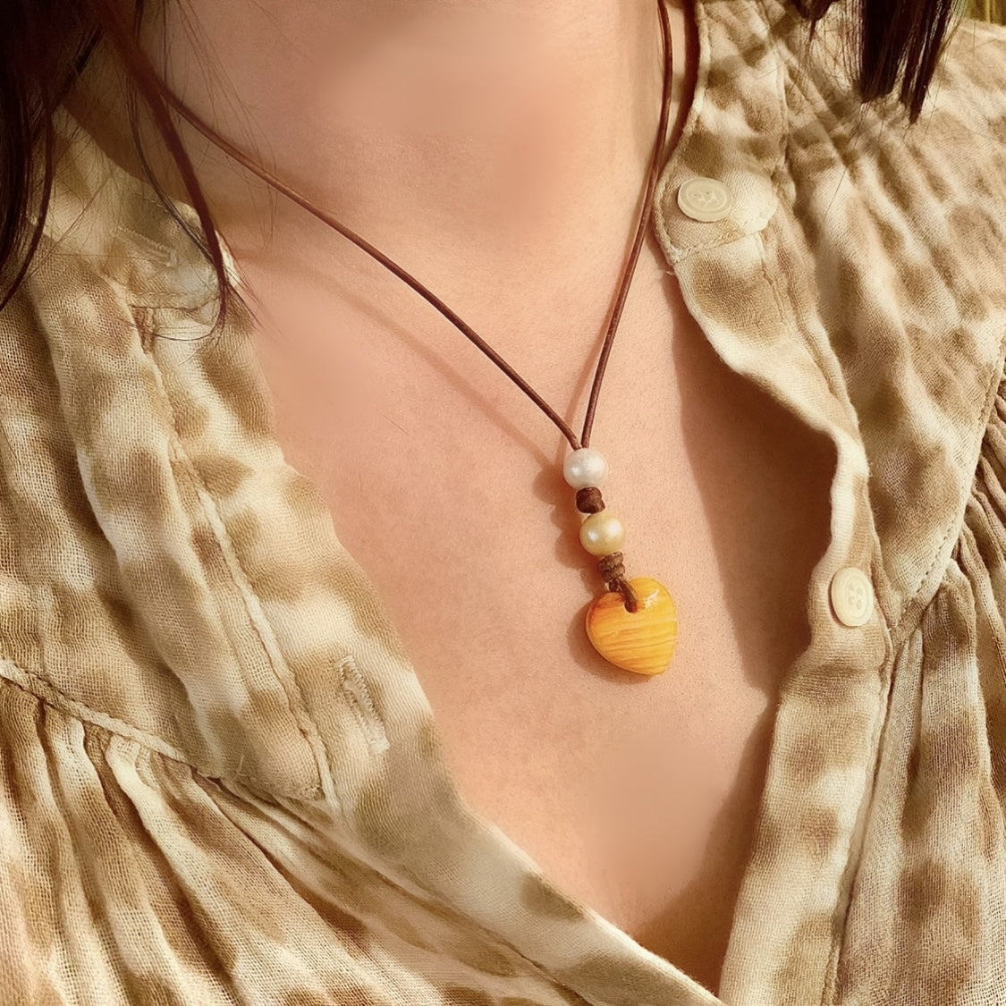 photo of Wendy Mignot Amour Saba Double Pearl and Leather Heart Necklace - Lions Paw Shell